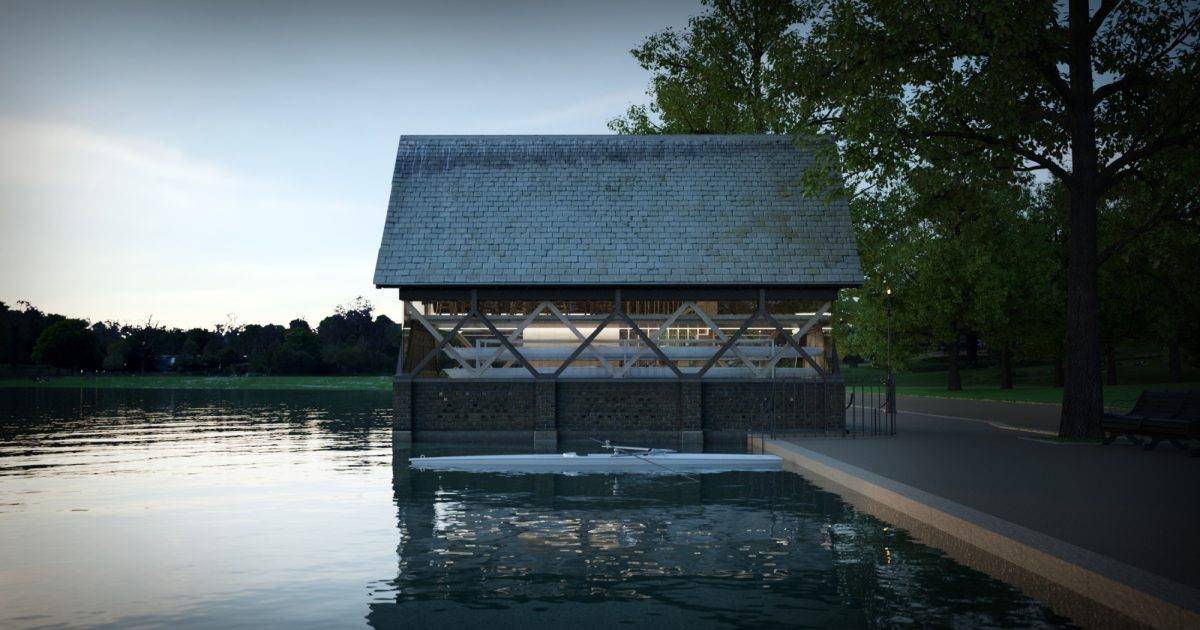 Moxon Architects Ltd — A boathouse partially submerged in a calm lake, surrounded by trees. The building has a wooden structure with a shingled roof. The water reflects the